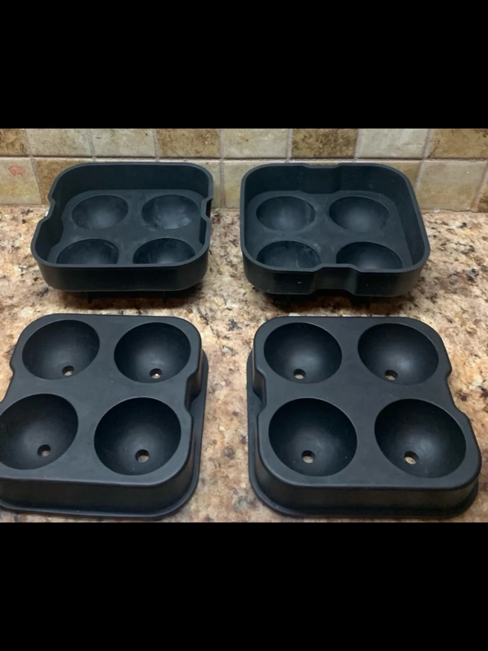 Four-hole silicone ice ball maker (2) trays with lids.